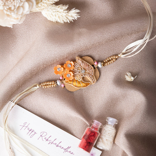 Wooden Base Orange Flower Rakhi With Roli Chawal Set