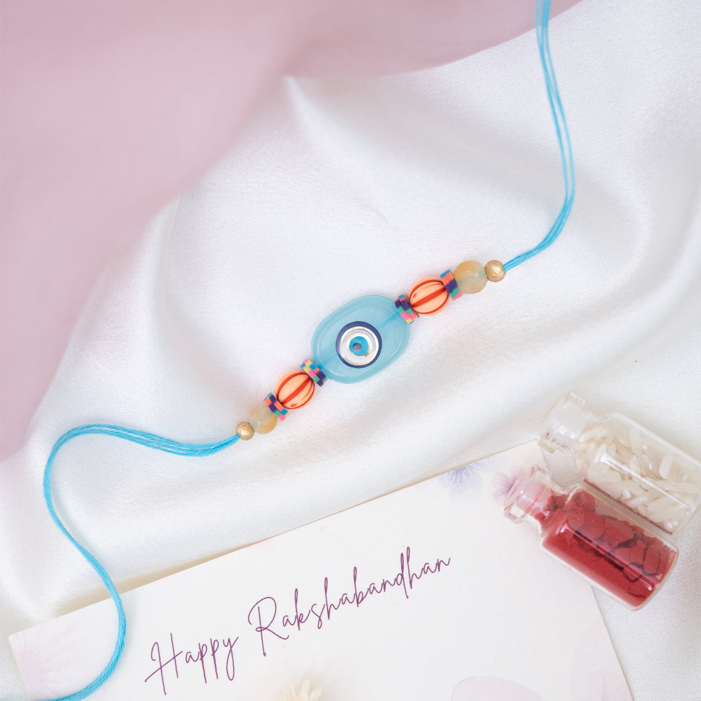 Quirky Evil Eye Resin Rakhi in Blue With Roli Chawal Set