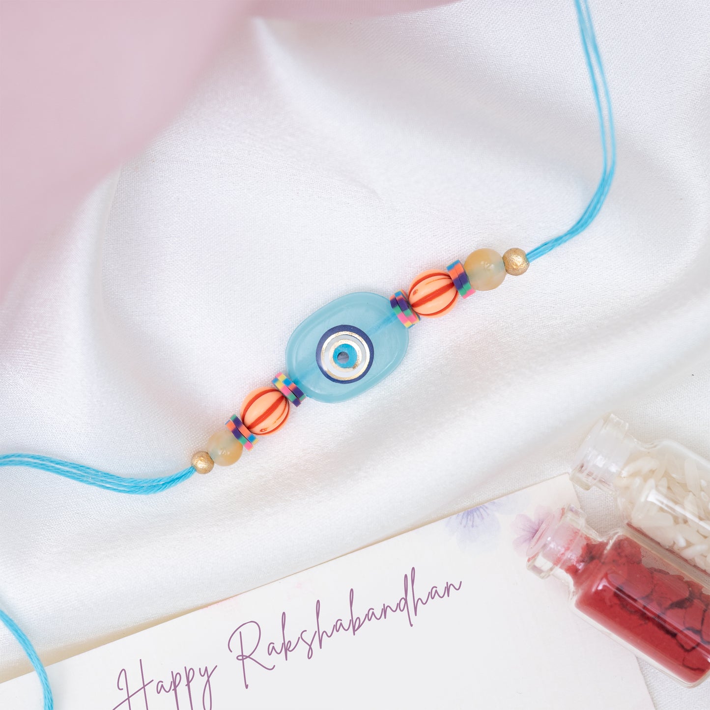 Quirky Evil Eye Resin Rakhi in Blue With Roli Chawal Set
