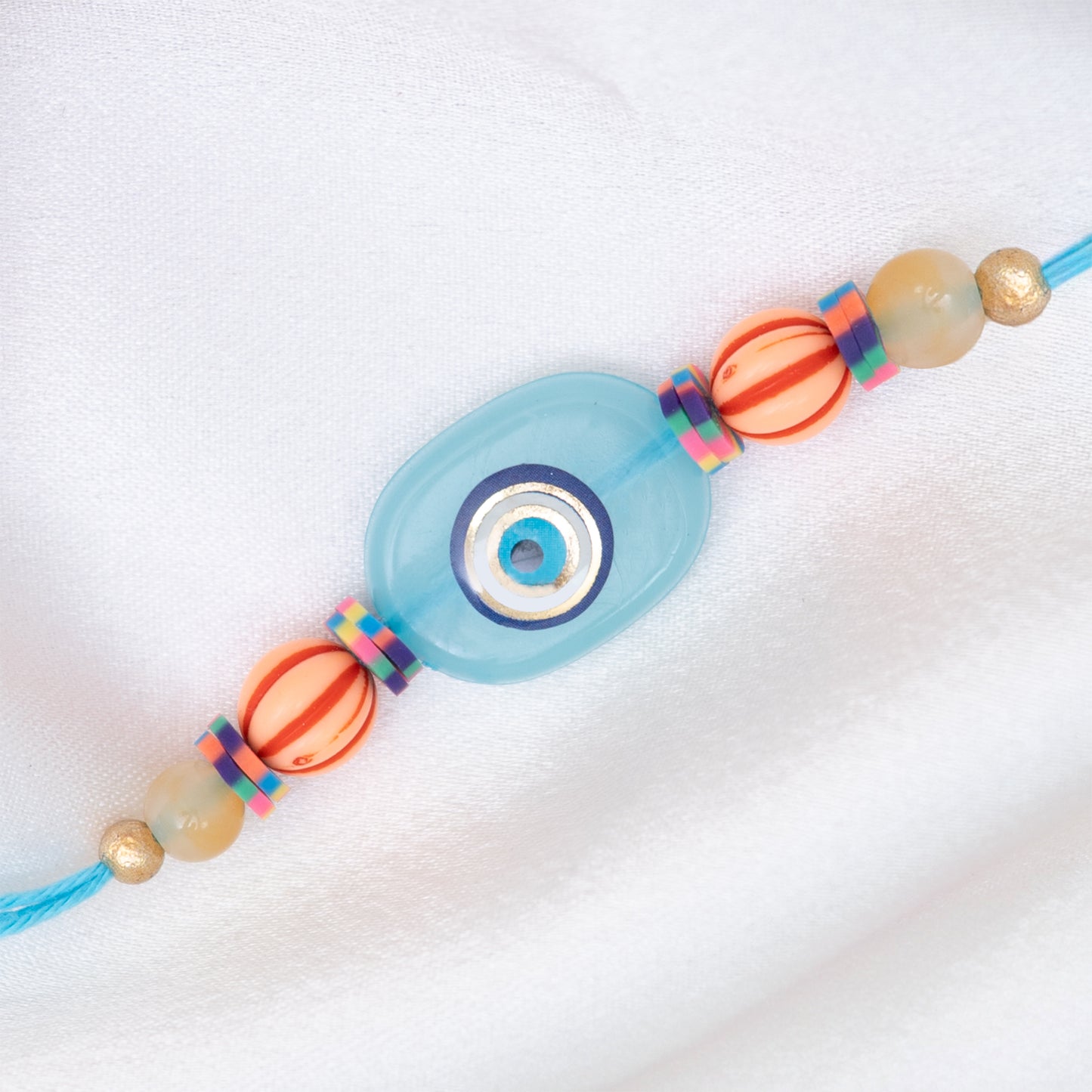 Quirky Evil Eye Resin Rakhi in Blue With Roli Chawal Set