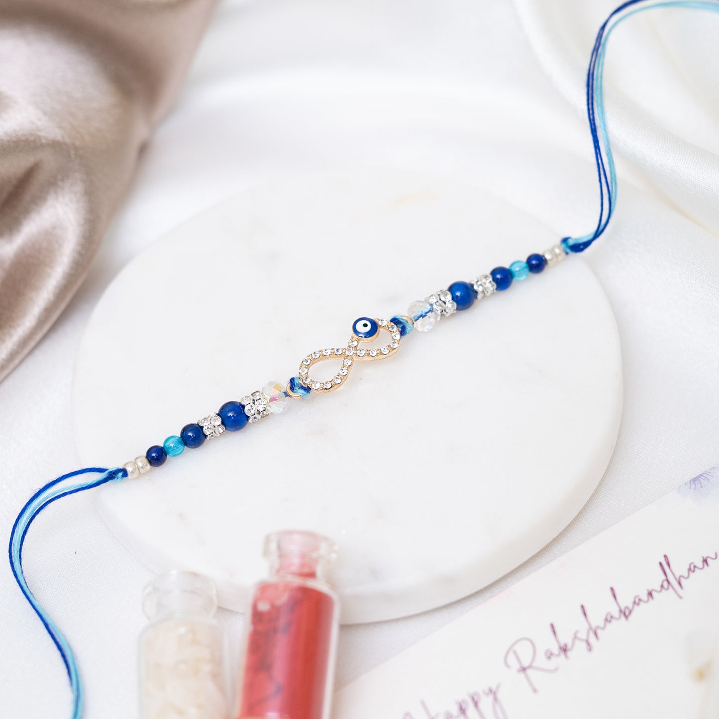 Evil Eye Stone-Studded Rakhi Set of 3 With Roli Chawal Set