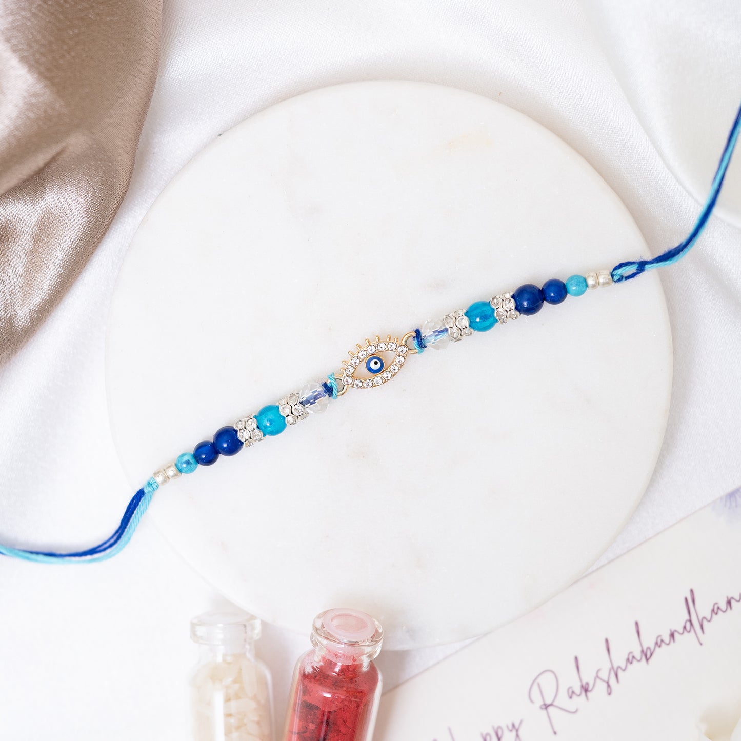 Evil Eye Stone-Studded Rakhi Set of 3 With Roli Chawal Set