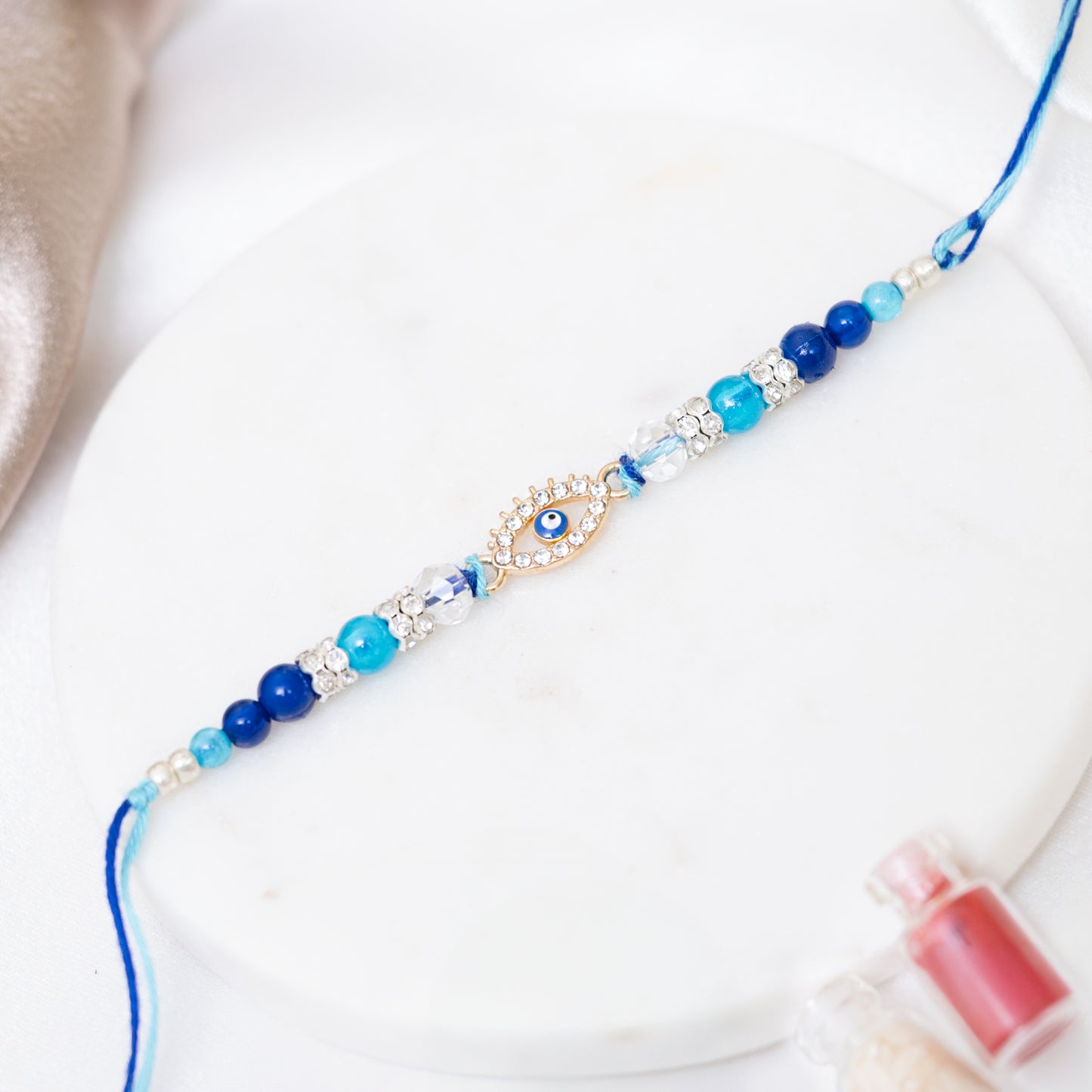 Evil Eye Stone-Studded Rakhi Set of 3 With Roli Chawal Set