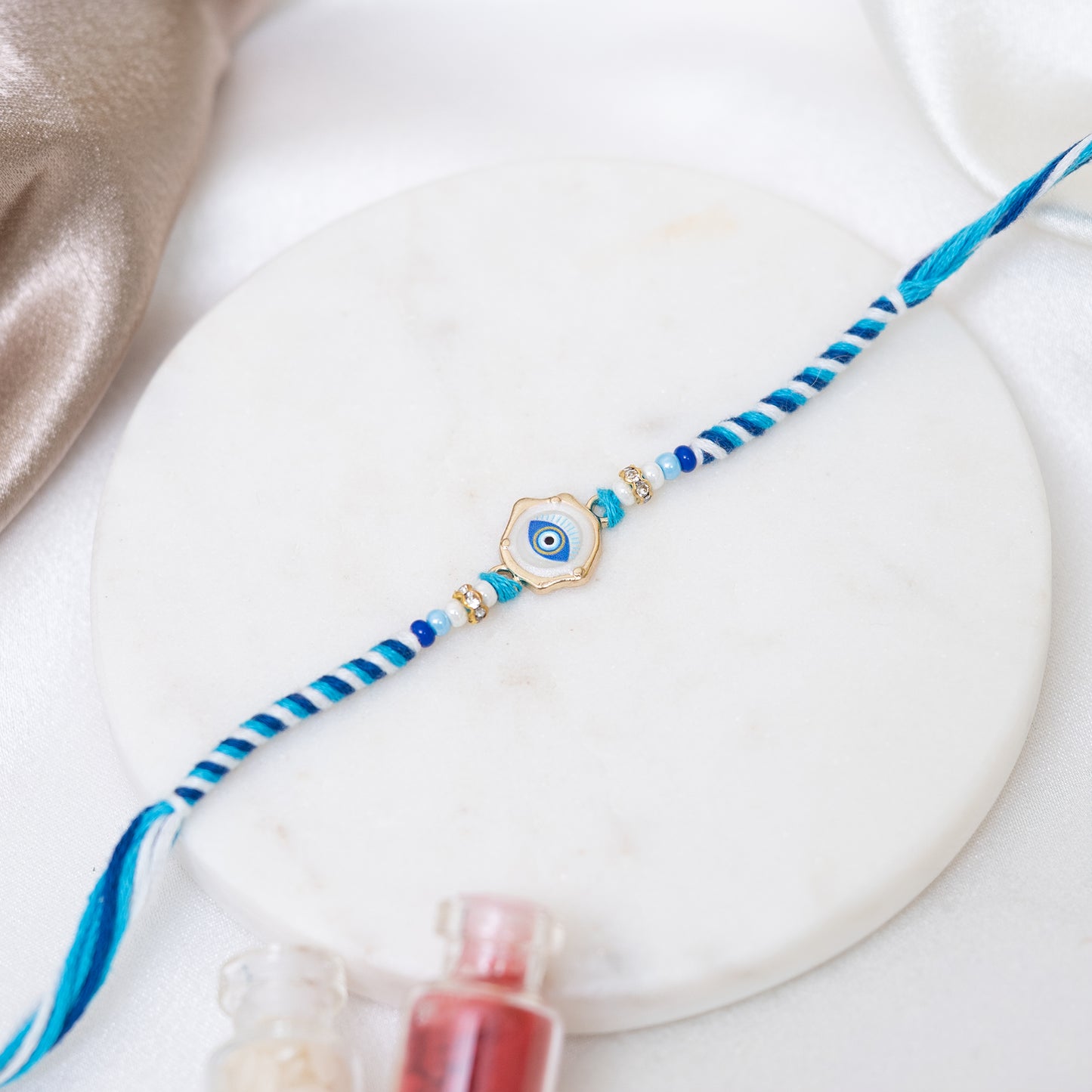 Marble Glow Evil Eye braided Rakhi With Roli Chawal Set