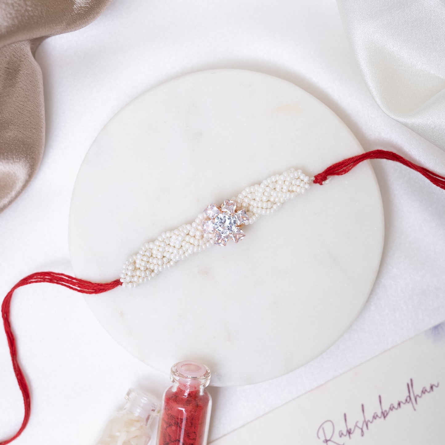 Pearl Twist with Floral Shine Rakhi With Roli Chawal Set