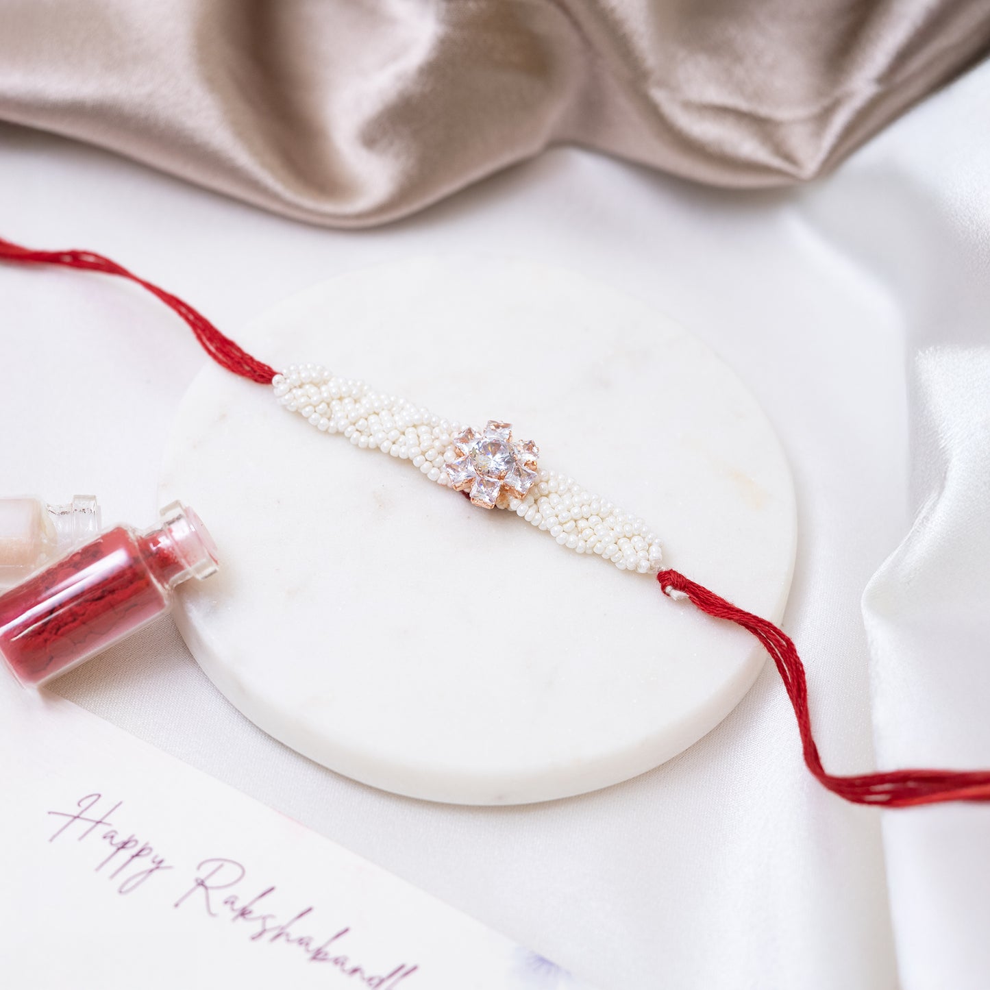 Pearl Twist with Floral Shine Rakhi With Roli Chawal Set