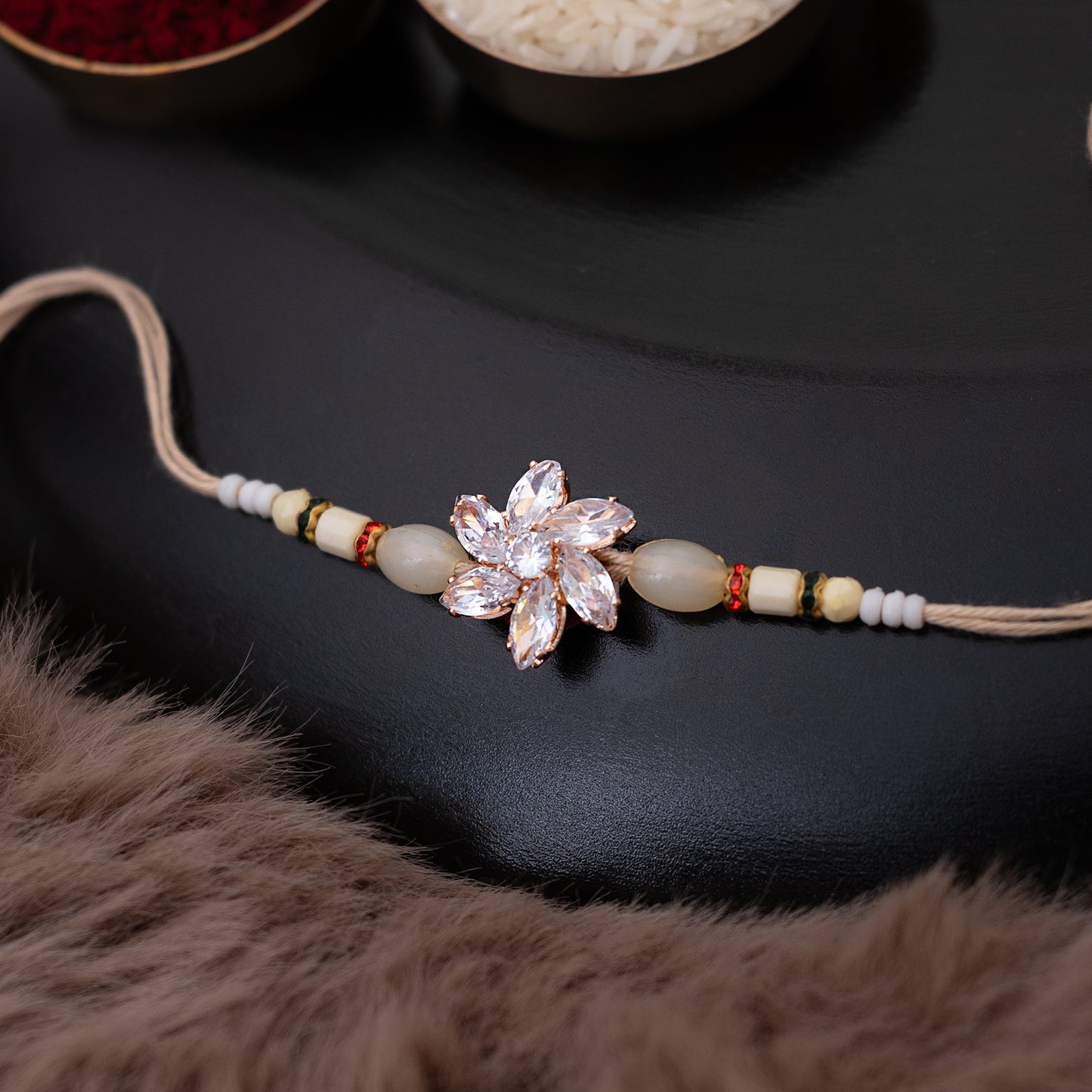 Crystal Blossom Rakhi in Beige Color With Roli Chawal Set