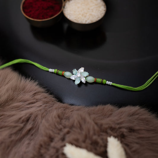 Crystal Blossom Rakhi in light green Colour With Roli Chawal Set