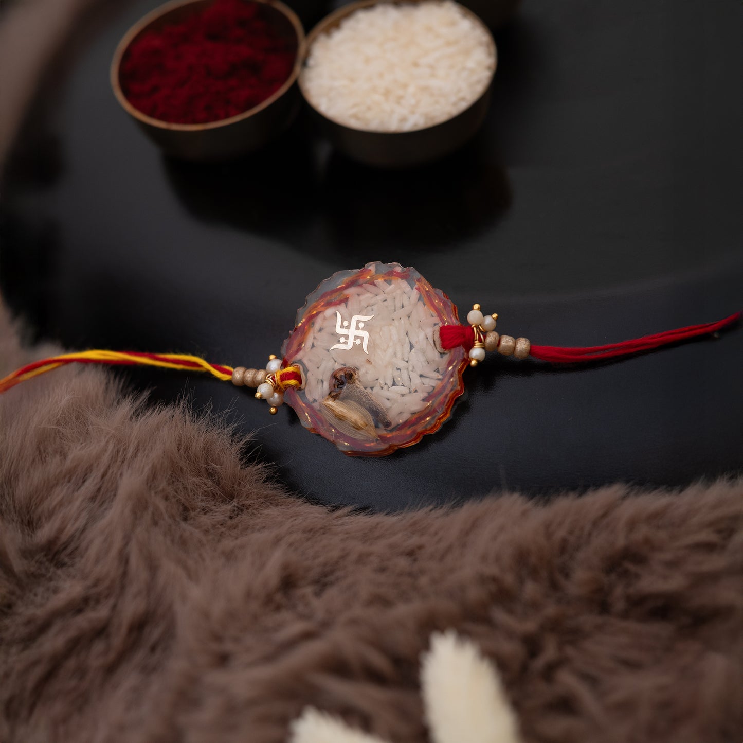 Laung, elaichi Resin Rakhi with mauli, rice and swastik blessing with set of ROLI CHAWAL