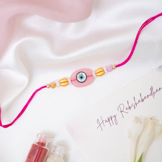 Quirky Evil Eye Resin Rakhi in Pink With Roli Chawal Set