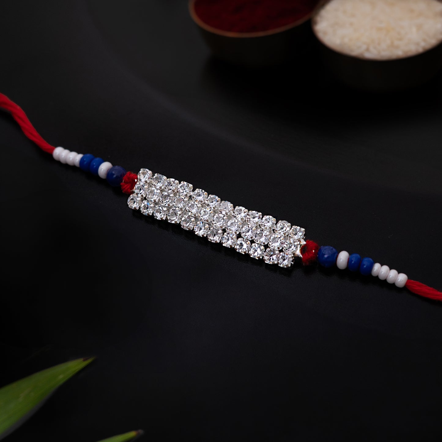 Shiny AD Stone Bhai Rakhi. Set of 2 With Roli Chawal Set