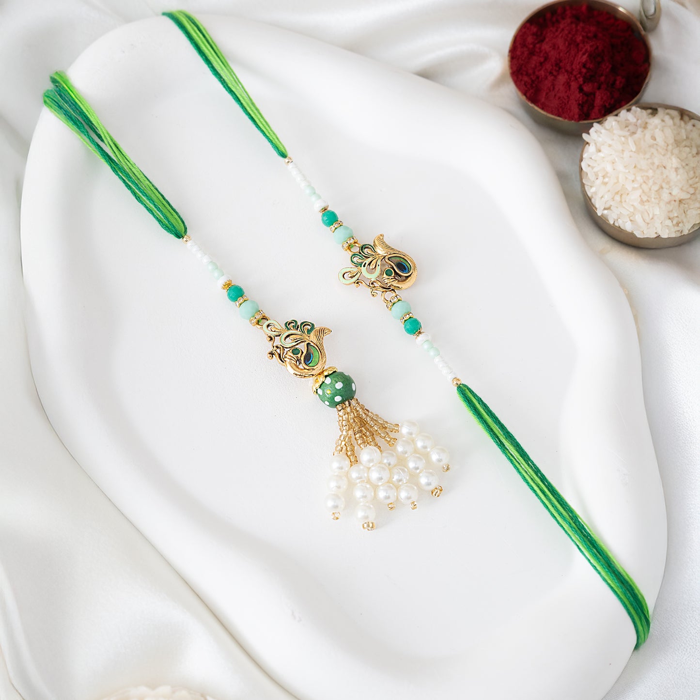 Regal Bhai-Bhabhi Peacock Rakhi Pair with Luxury Tassels With Roli Chawal Set