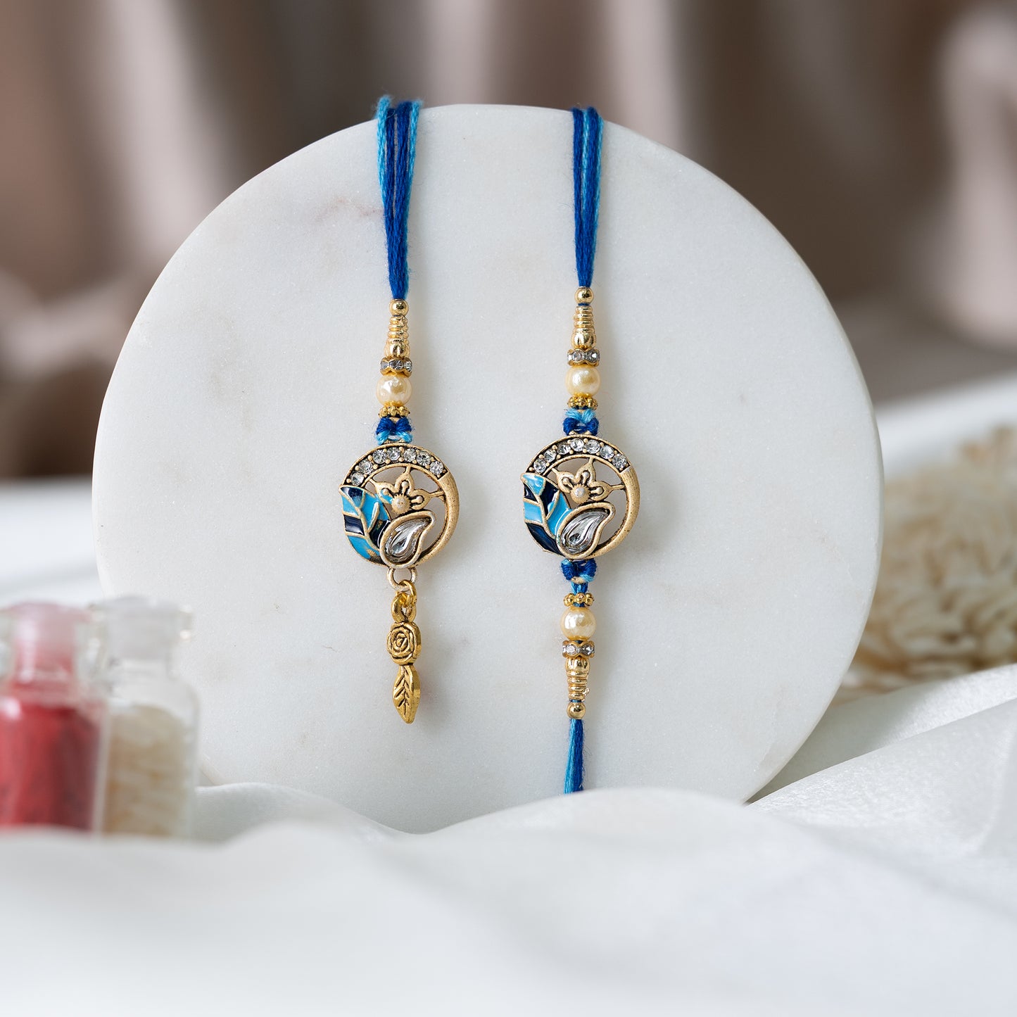 Chic Blue Leaf Rakhi Set for Him & Her With Roli Chawal Set