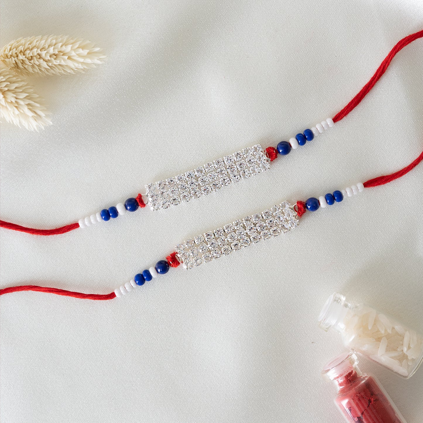 Shiny AD Stone Bhai Rakhi. Set of 2 With Roli Chawal Set