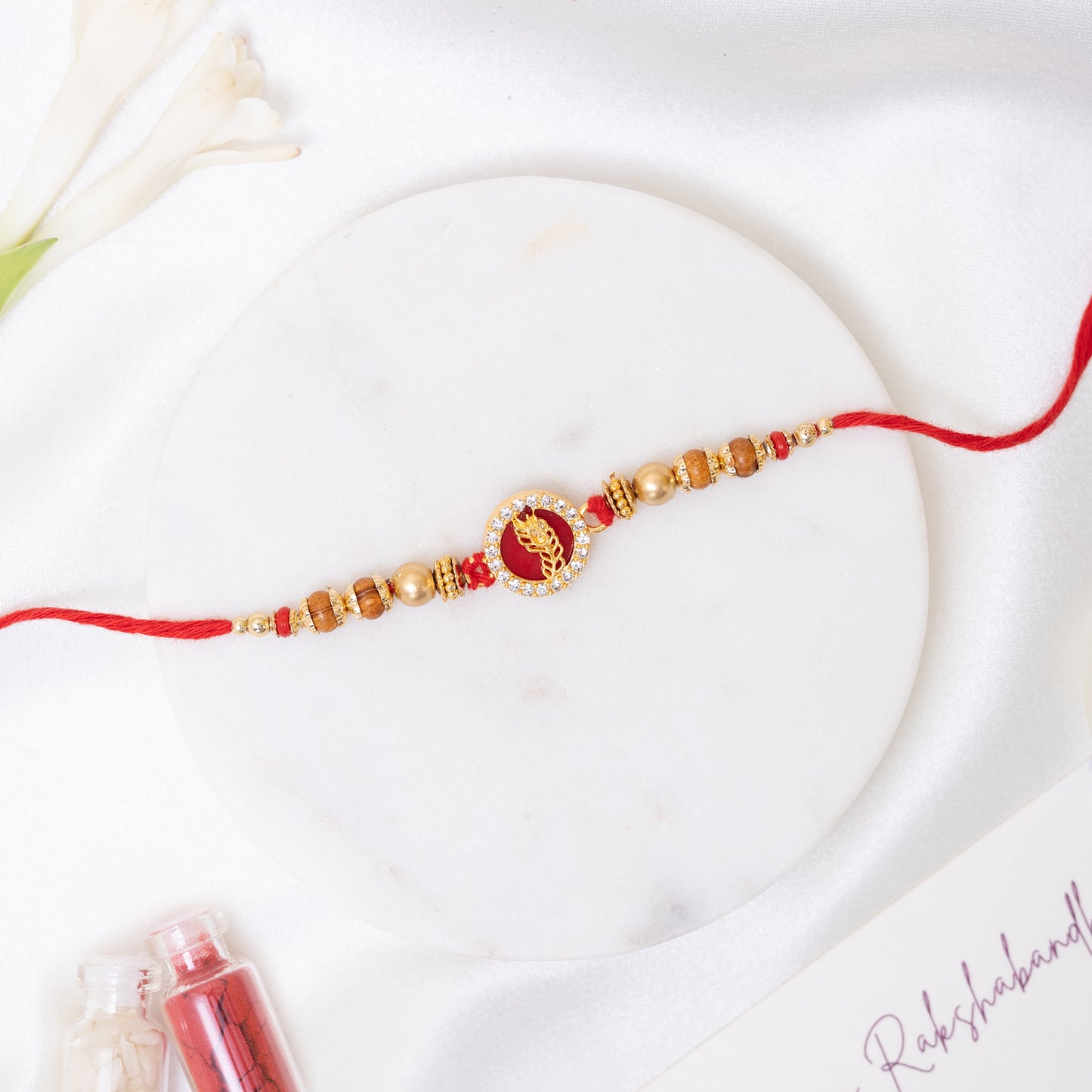 Peacock Glory Rakhi in Red and Gold With Roli Chawal Set