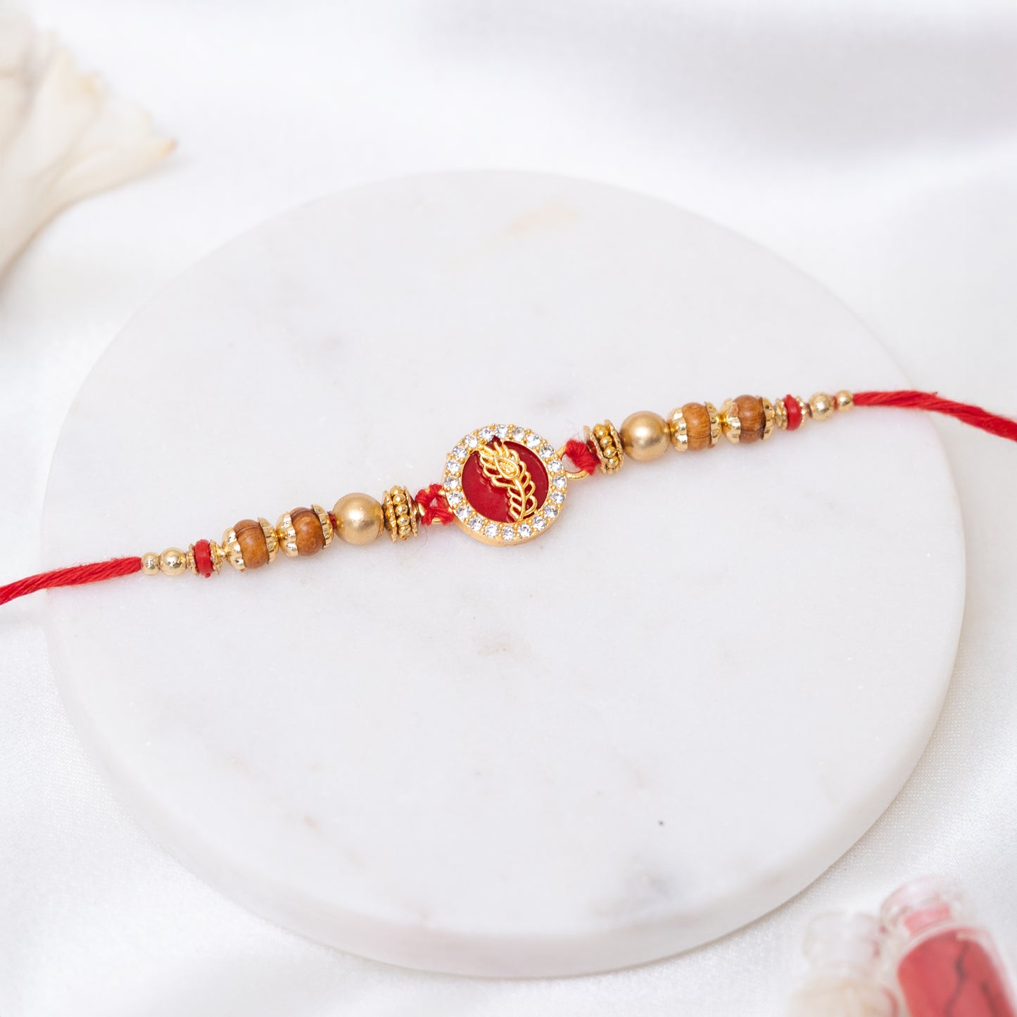 Peacock Glory Rakhi in Red and Gold With Roli Chawal Set