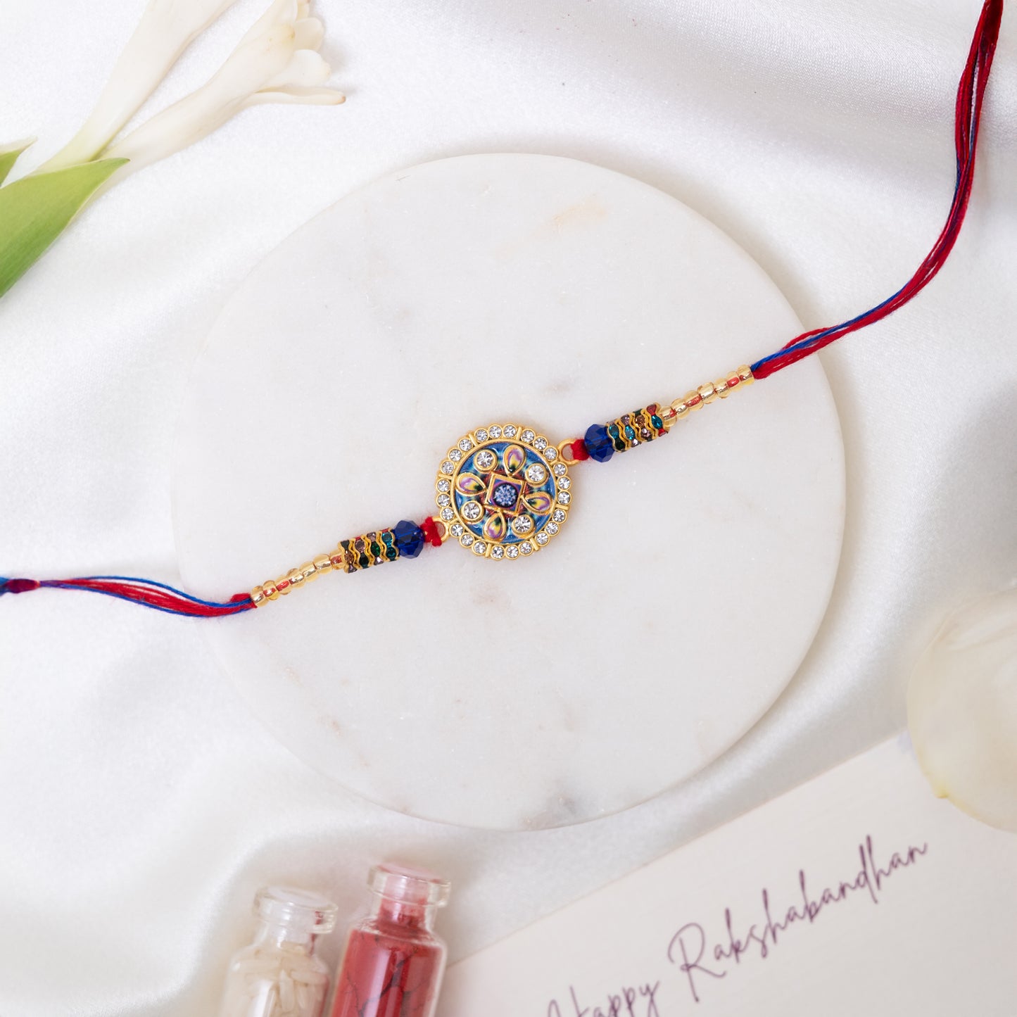 Stone Studded Metal Rakhi. Set of 2 With Roli Chawal Set