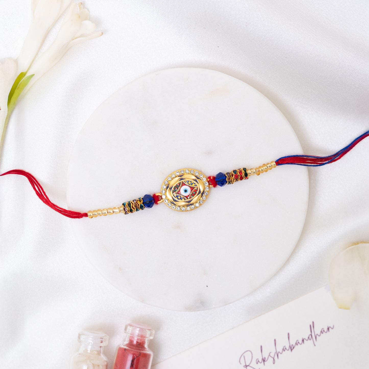 Stone Studded Metal Rakhi. Set of 2 With Roli Chawal Set