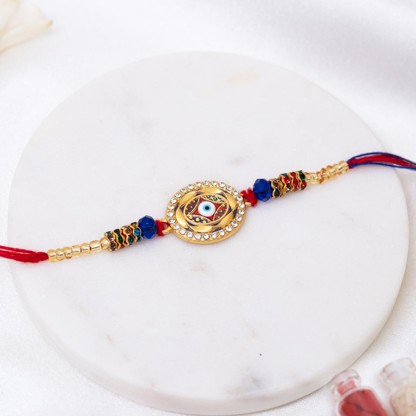 Stone Studded Metal Rakhi. Set of 2 With Roli Chawal Set