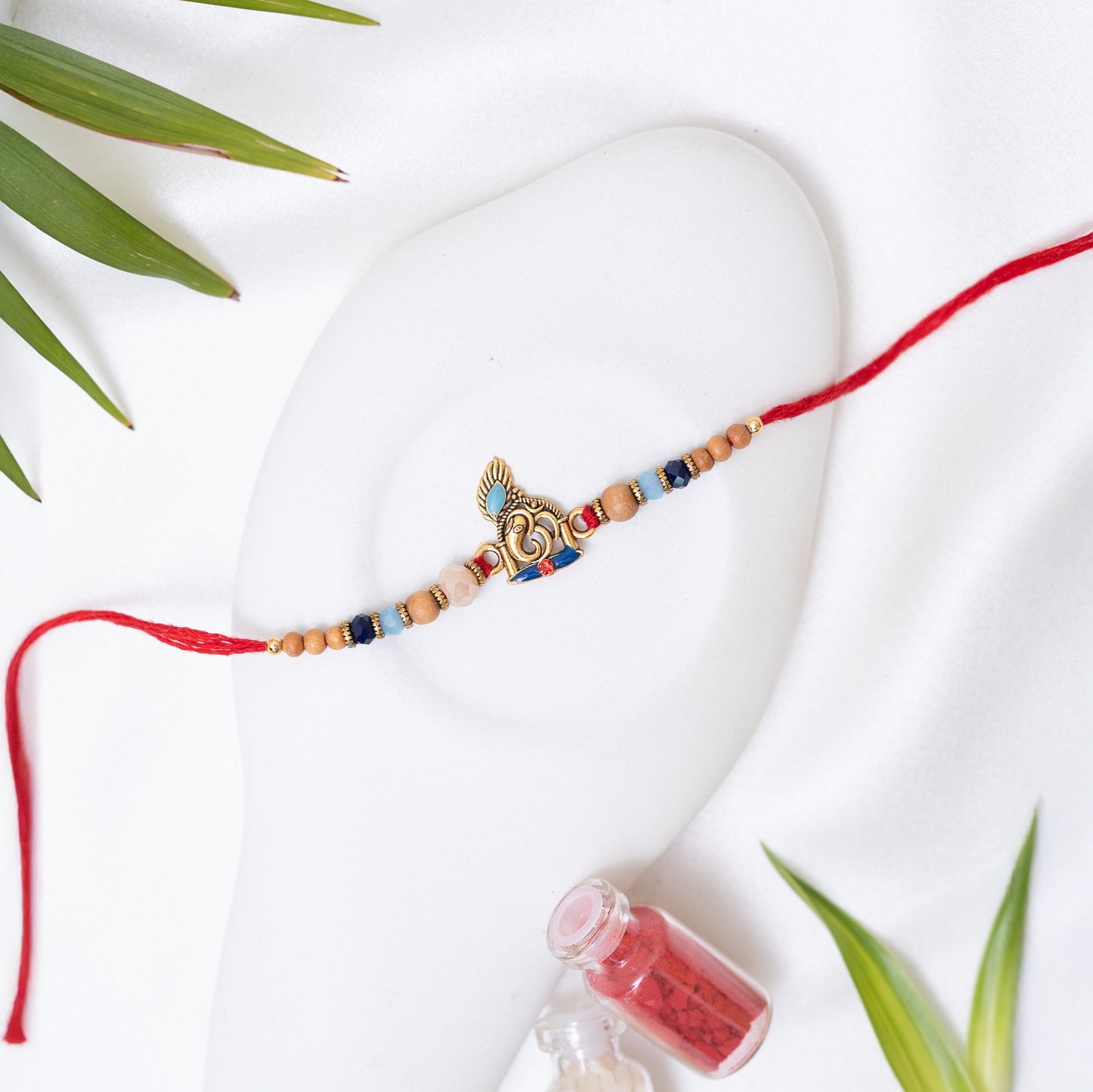 Antique Ganesha Rakhi Adorned with Rich Beads with Roli Chawal Set