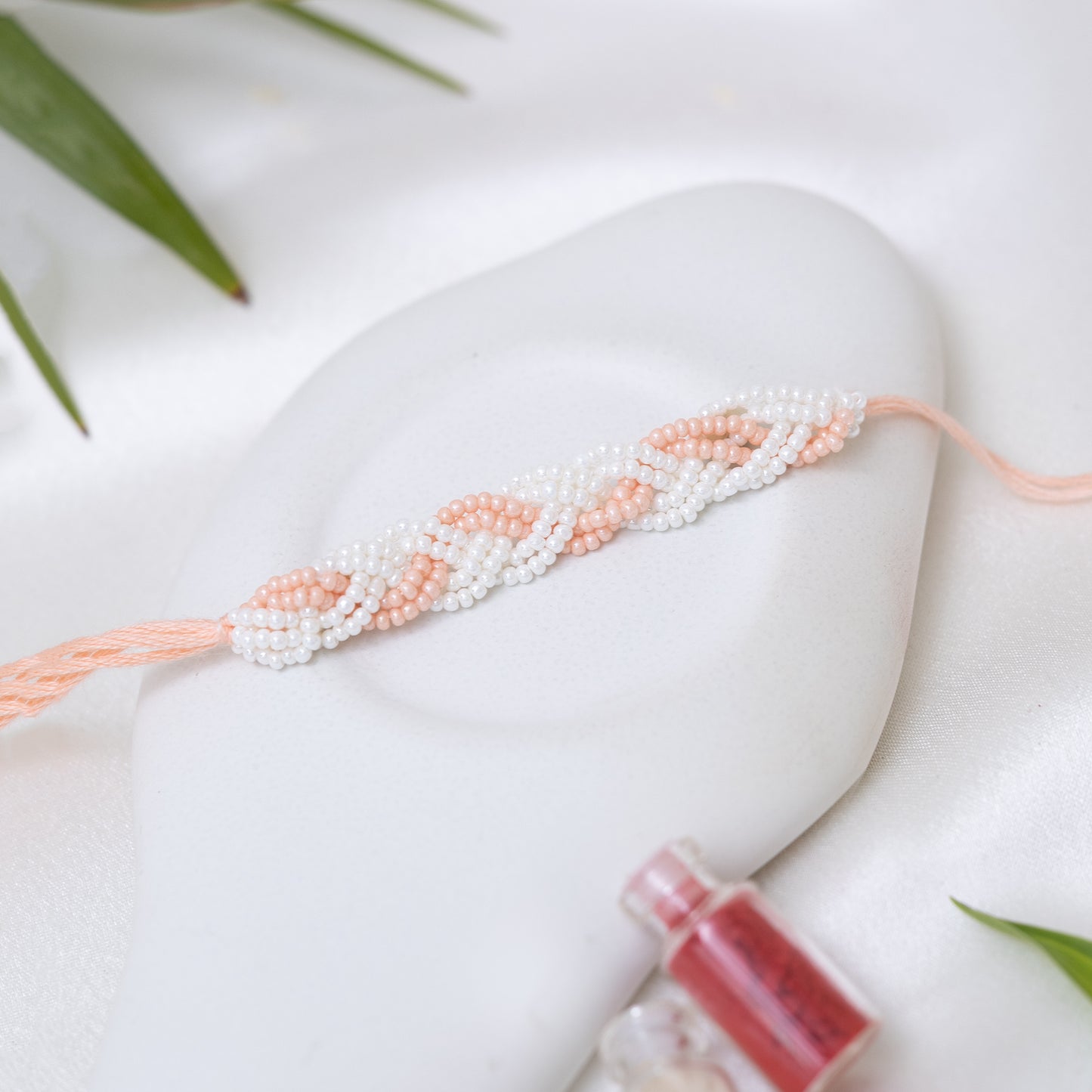 Braided Pearl Rakhi. Set of 2 With Roli Chawal Set