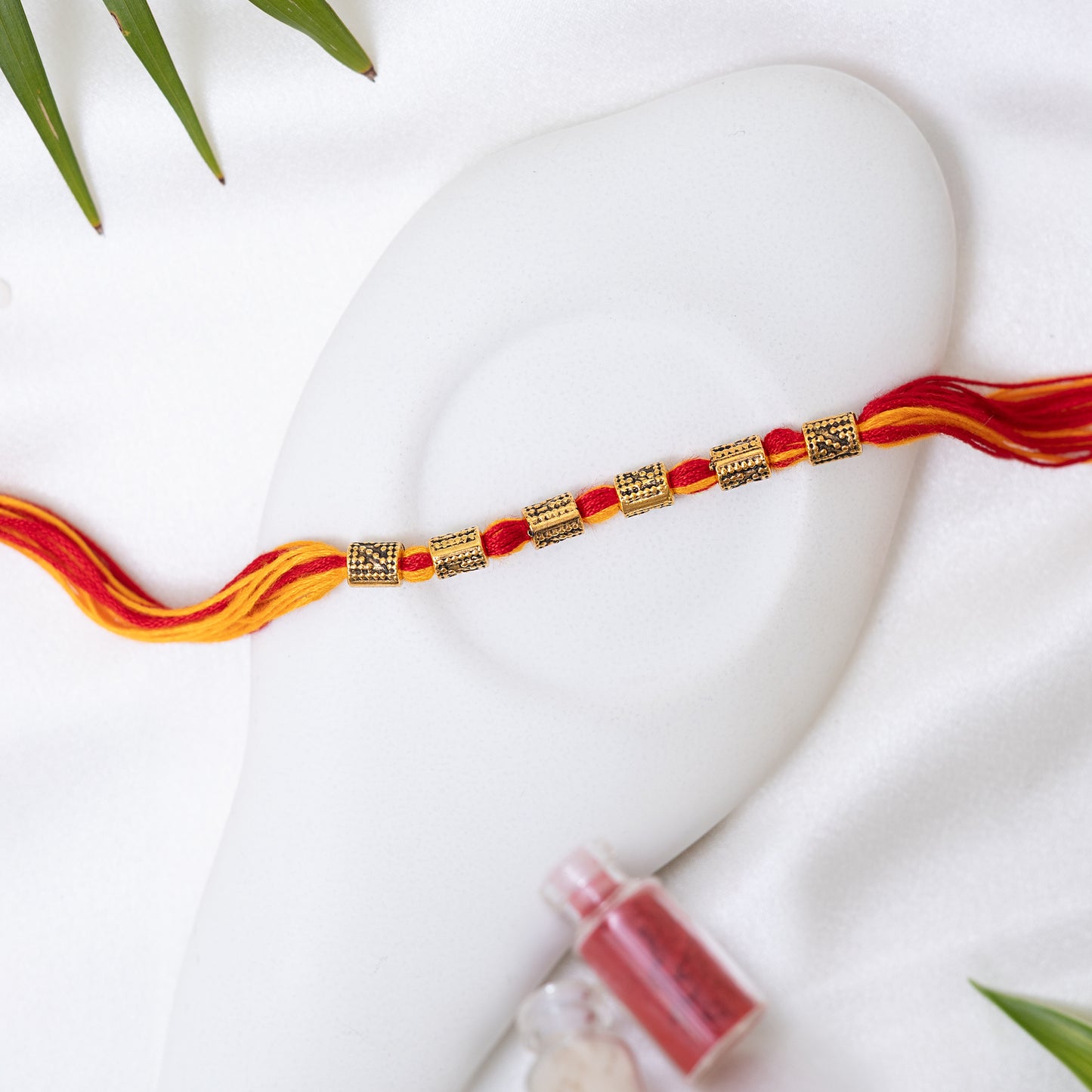 Red-Yellow Rakhi with Antique Charm set of 3 with Roli Chawal Set
